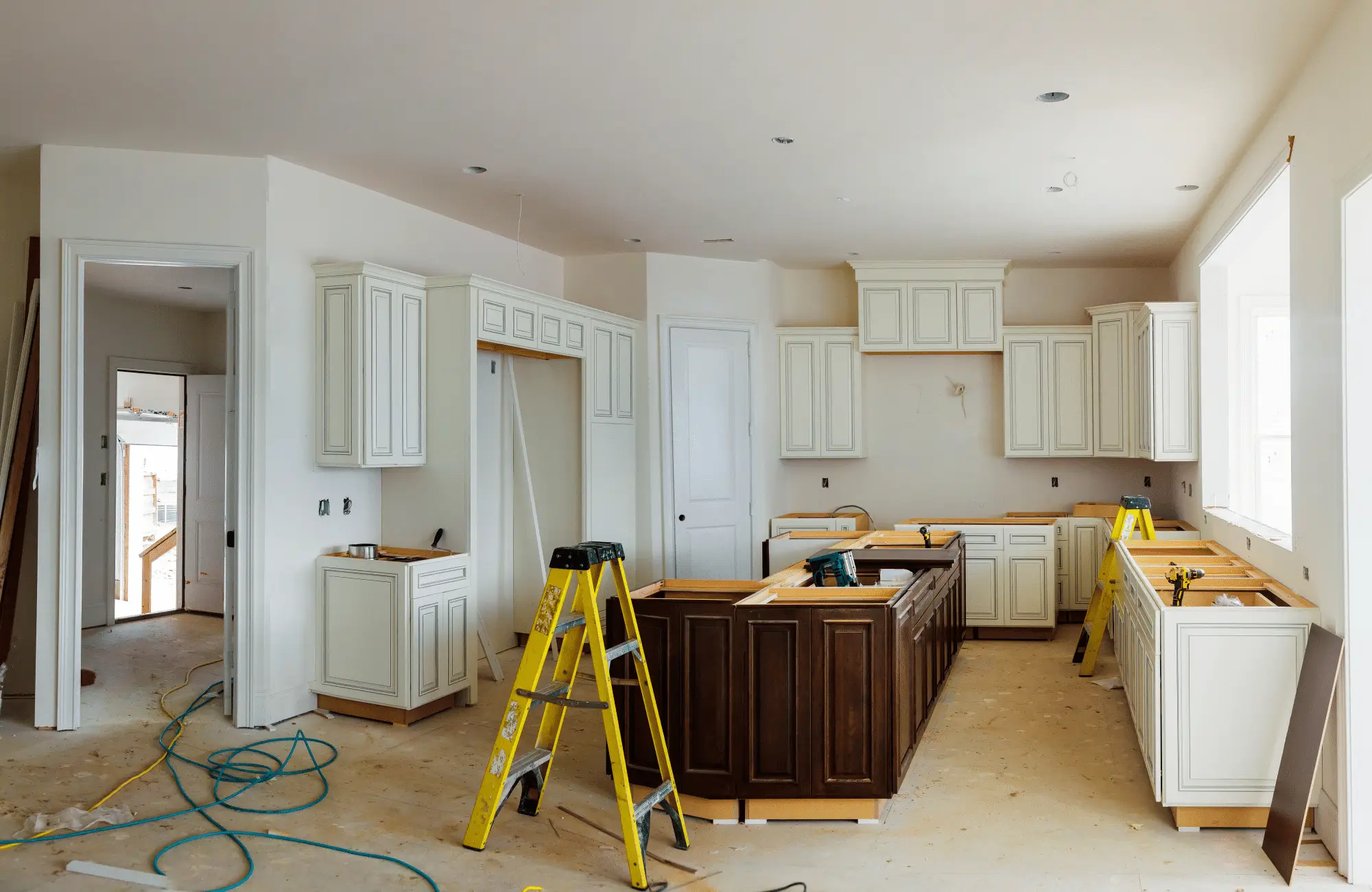 A kitchen renovation in progress, cabinets being installed for a modern look