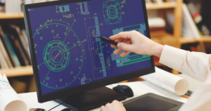 Engineer working on CAD software, analyzing technical mechanical drawings on a computer screen – Precision engineering and digital drafting.